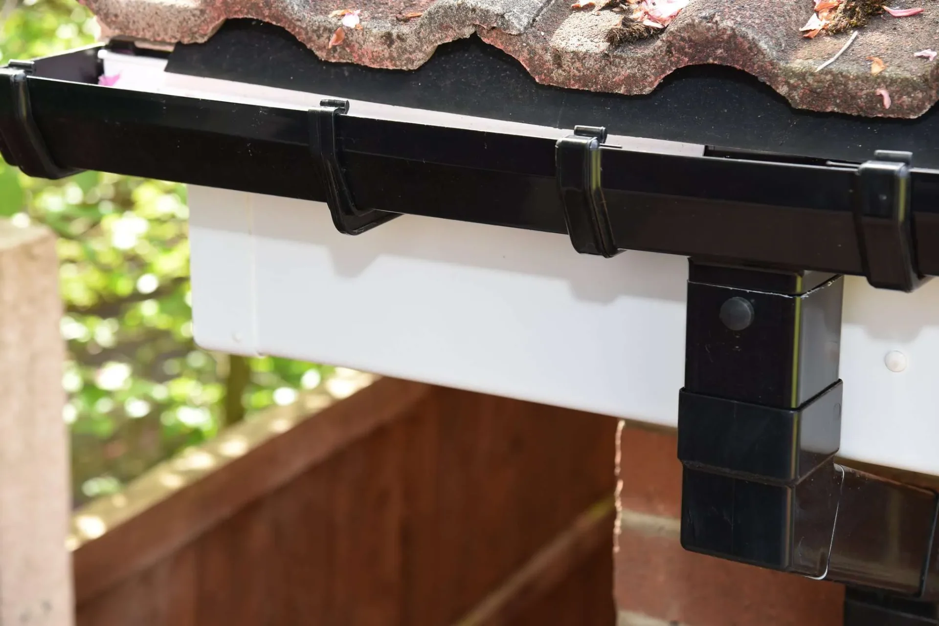 Black aluminium guttering and downpipe installation on North London terrace