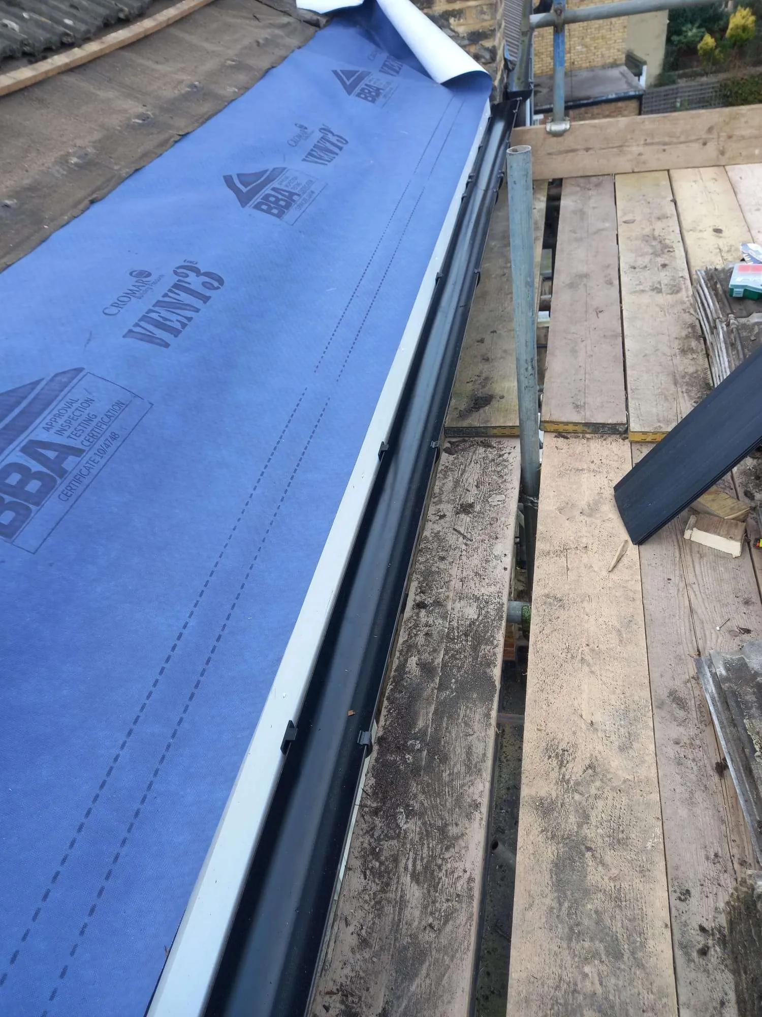 Cromar Vent3 breathable membrane being installed during roof replacement