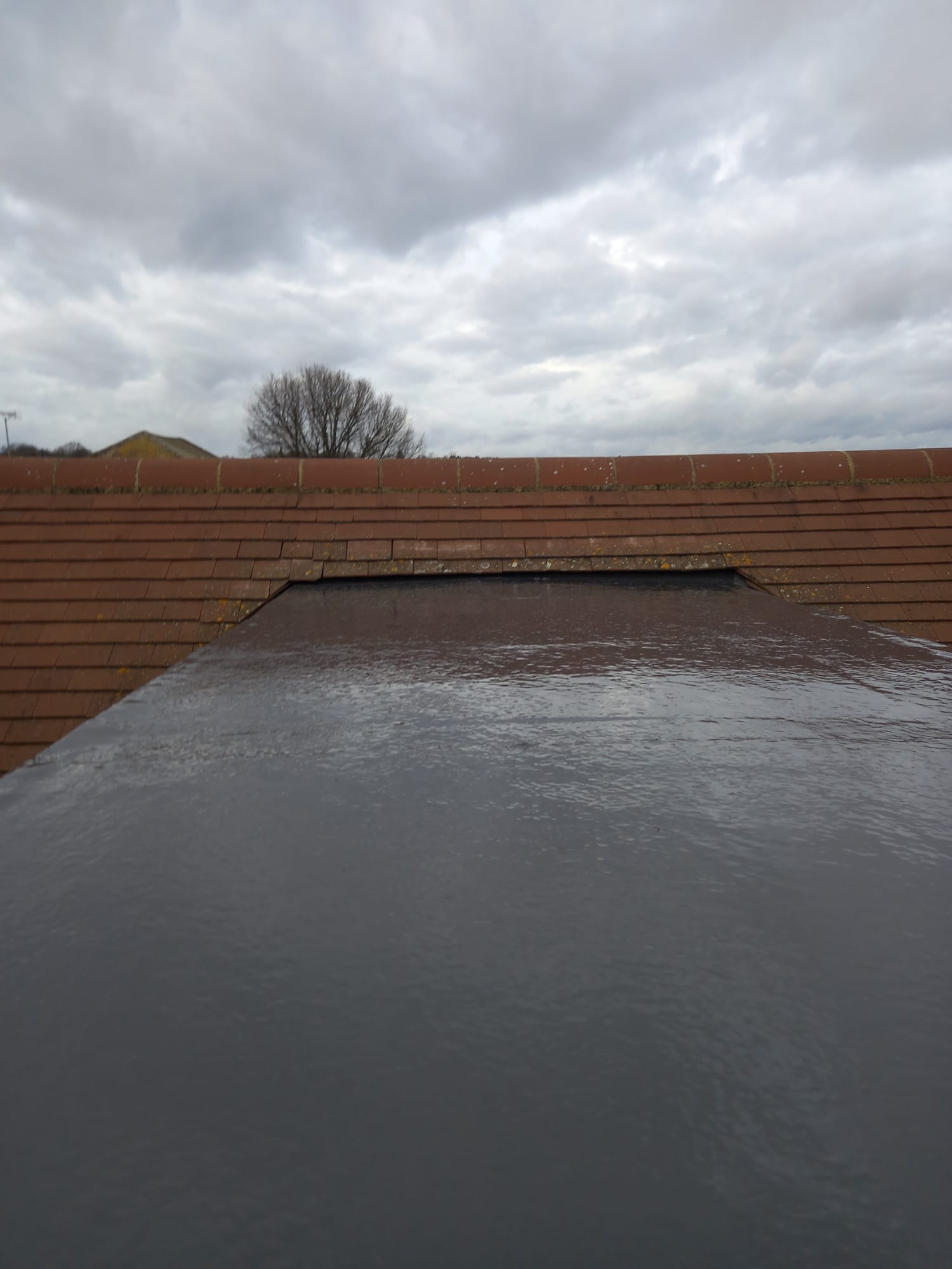 Felt roof with wet tiles on residential North London property