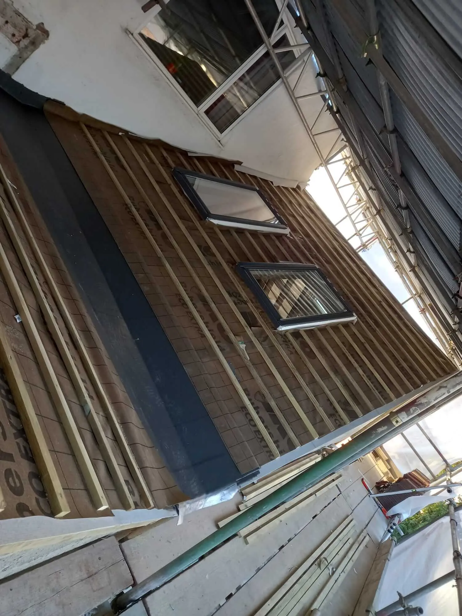 Dormer roof with Velux windows and timber battens during fibreglass roofing project