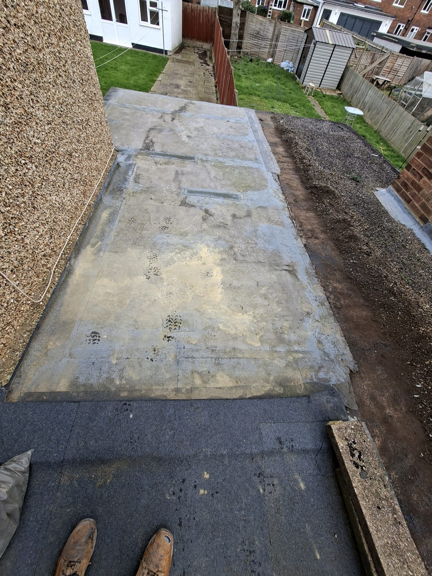 Flat roof surface showing wear before repair work