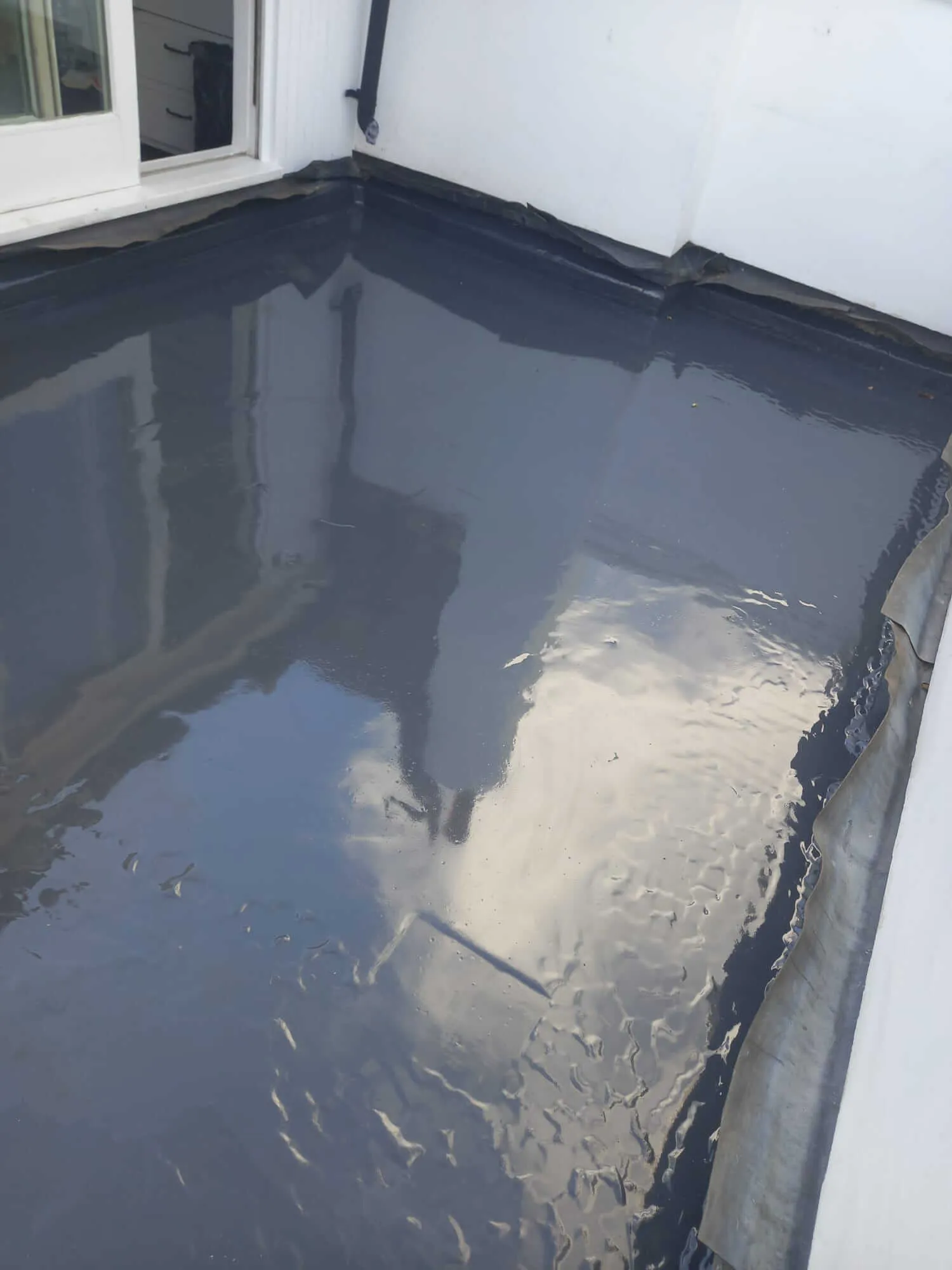 Commercial flat roof waterproofing detail on office building