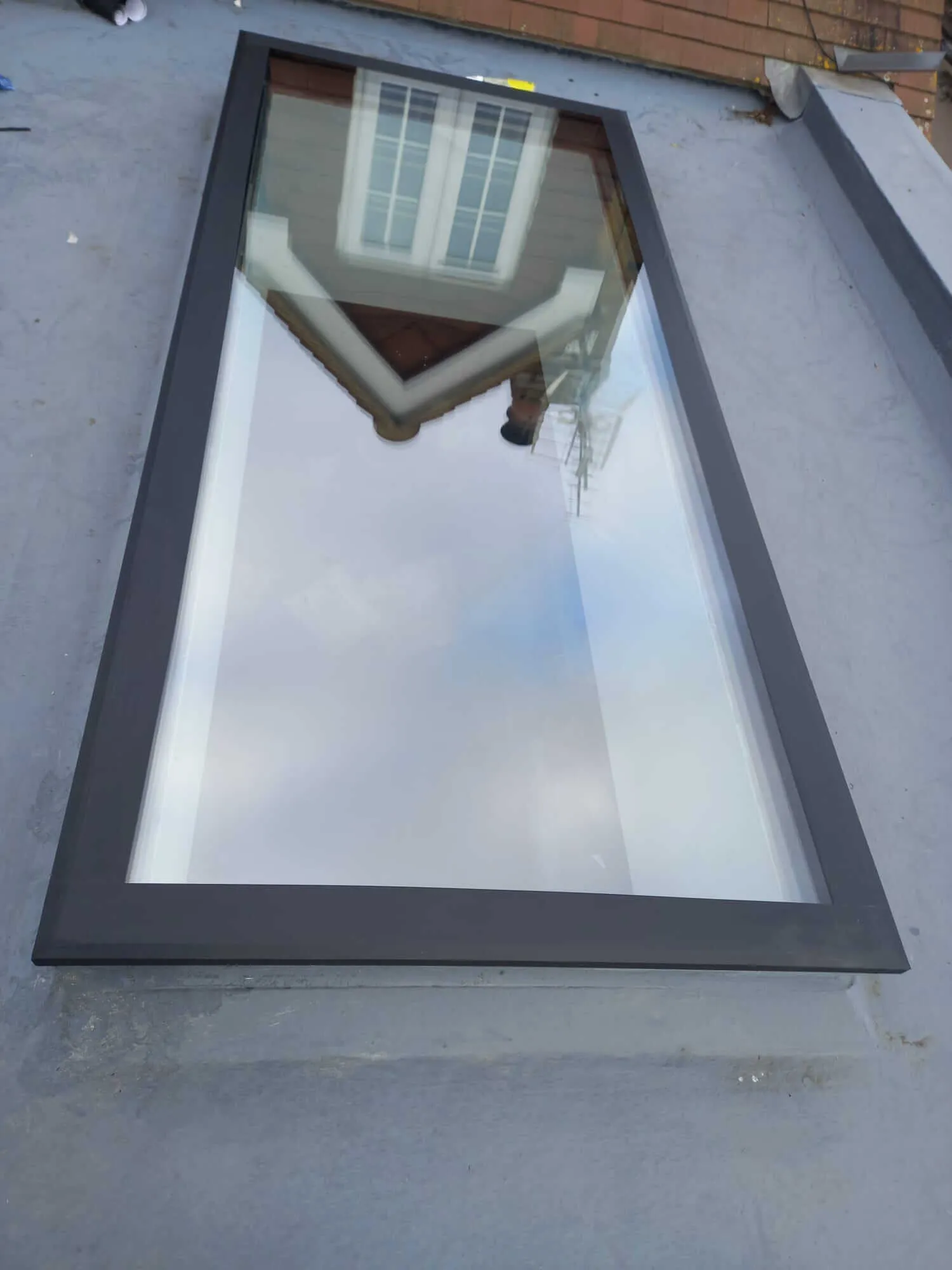Flat roof skylight detail showing seamless waterproof surround