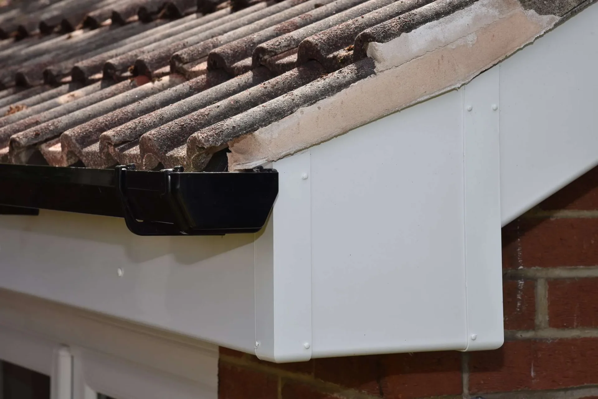 New white UPVC fascias and soffits with black aluminium guttering installed