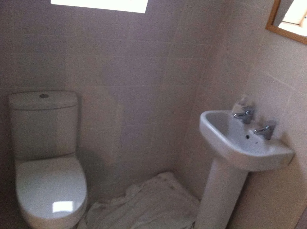 En-suite bathroom fitted in loft conversion with tiled walls and Velux skylight