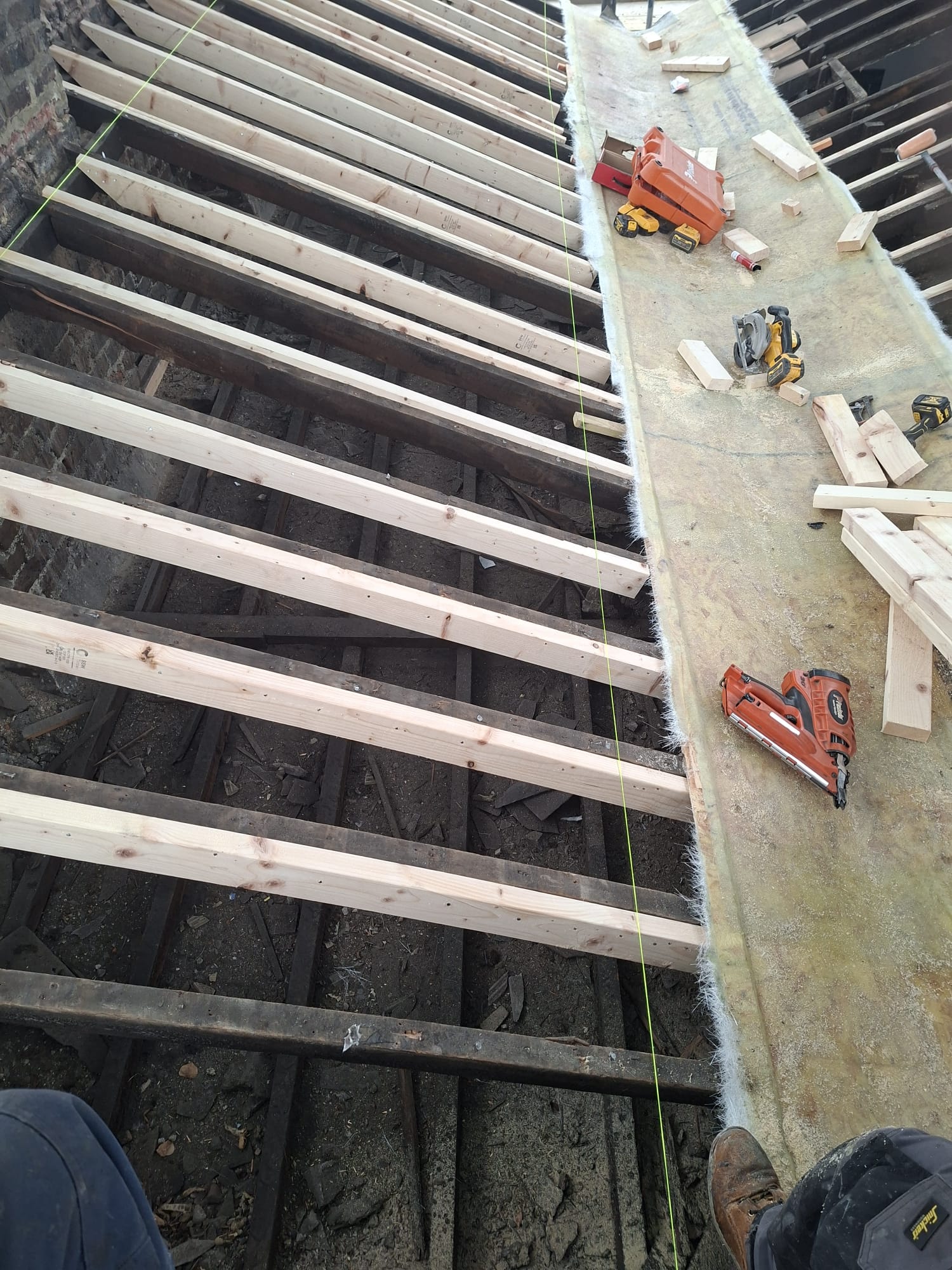 New floor joists and tools during loft conversion build