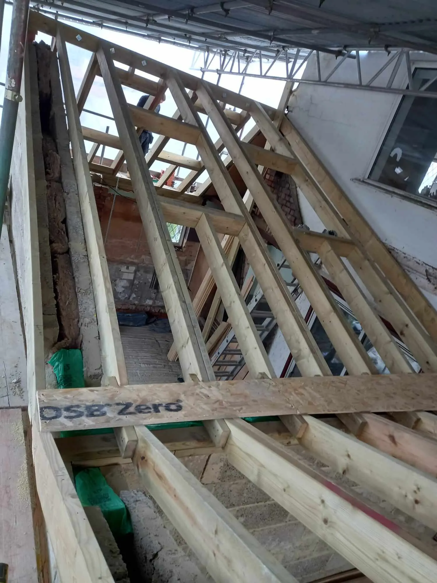 Loft conversion roof framing in progress with scaffolding