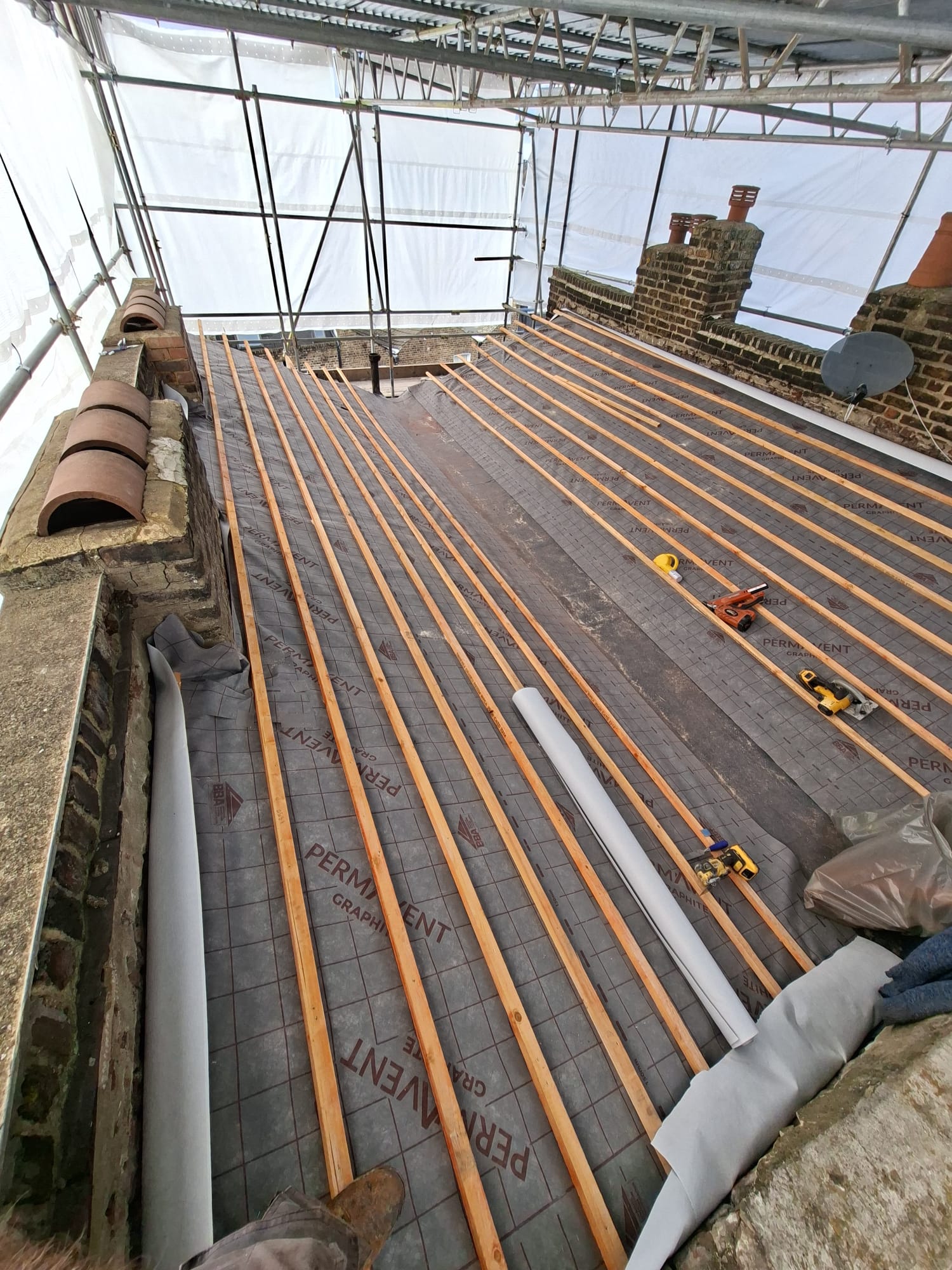 Permavent graphite membrane with timber battens under scaffolding