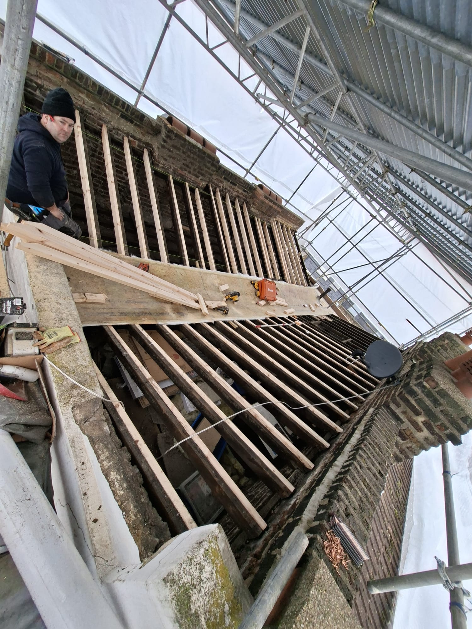 Roofer working on new roof rafter structure