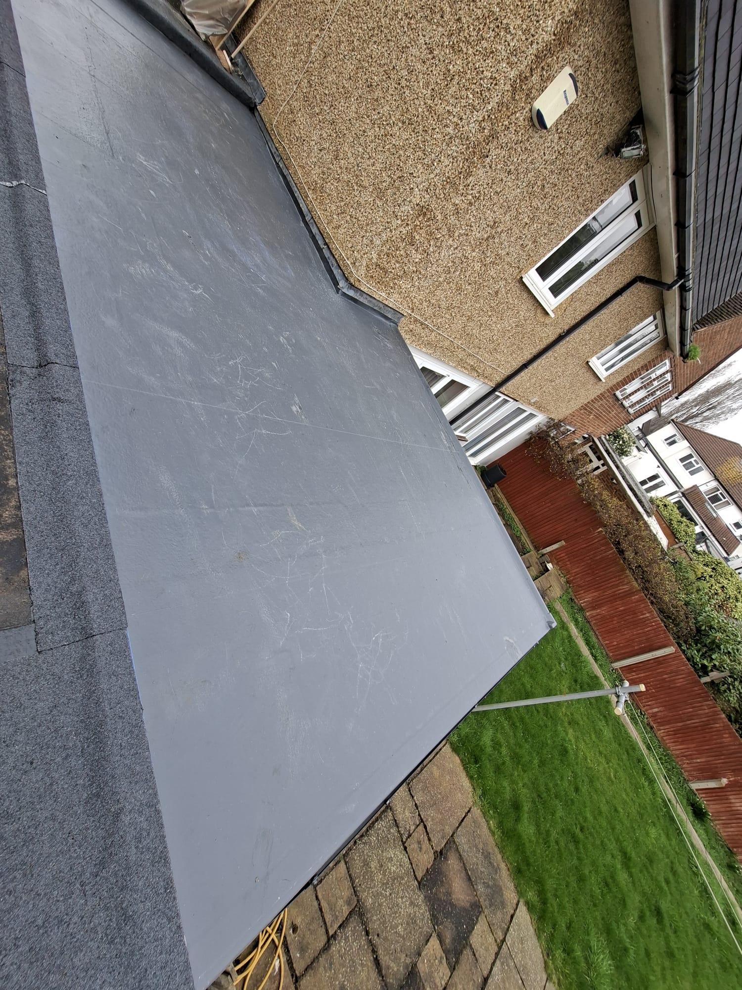 Side view of completed EPDM rubber roof on residential extension