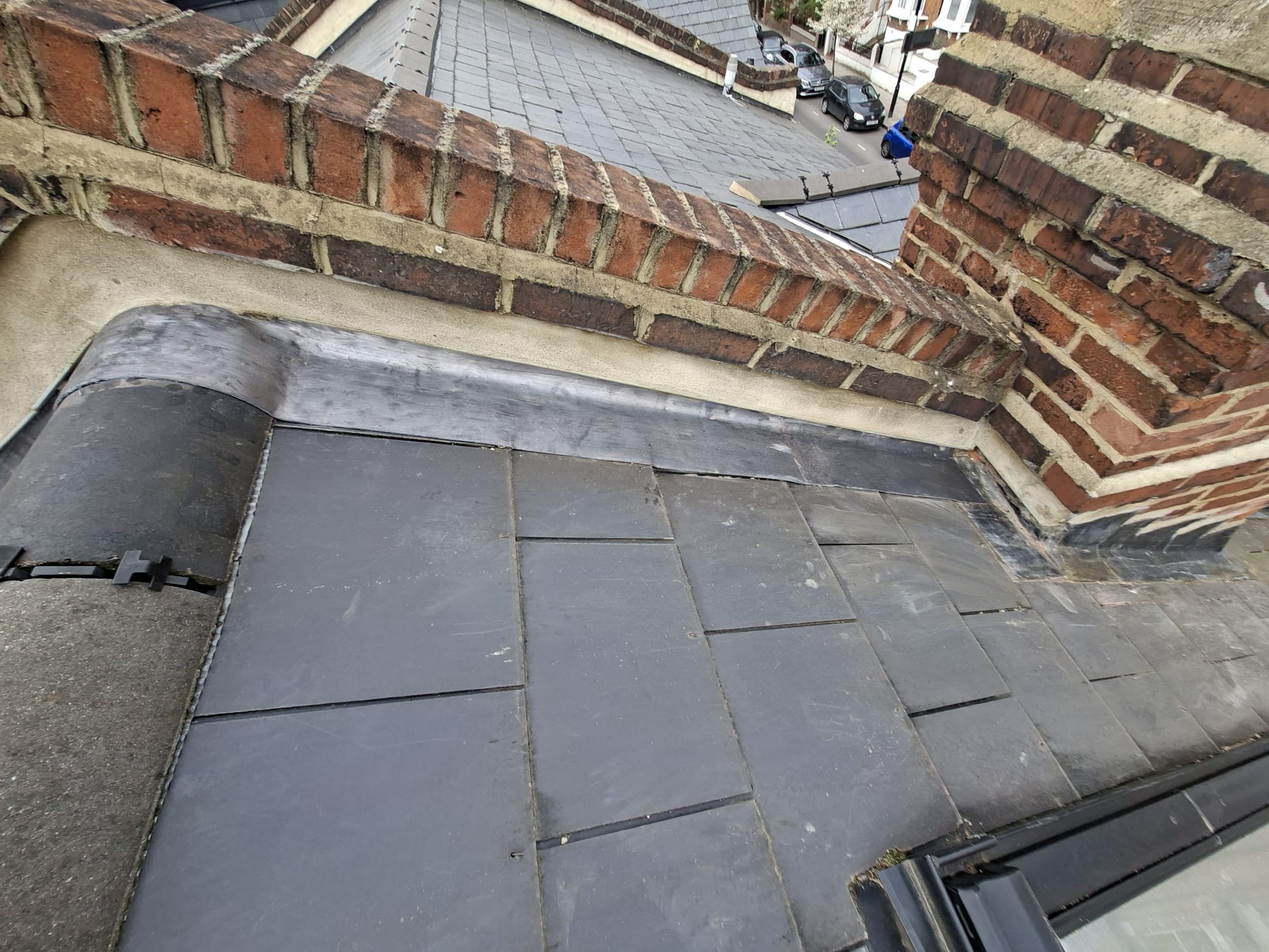 Slate roof with new lead flashing around chimney stack
