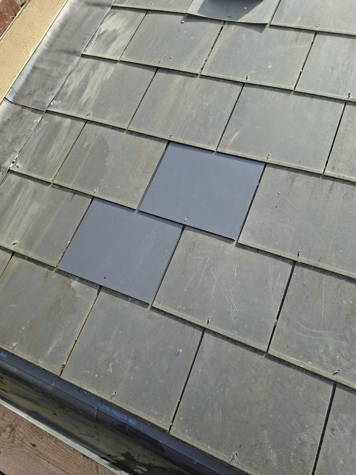 Slate tile replacement and repair on pitched roof