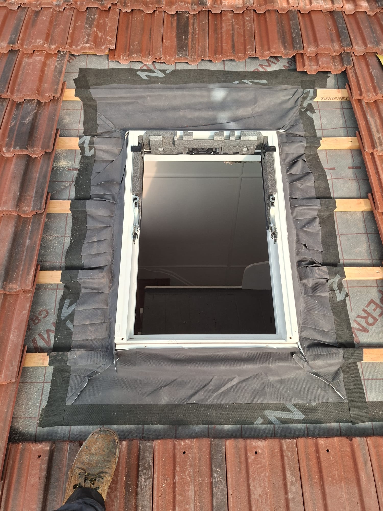 Velux skylight installed over breathable membrane on new roof